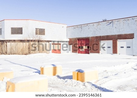 Industrial garage building with snowy foreground