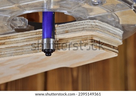 Wood router flush trim bit with double bearing. Template routing technic straight cut. Cam follower wood router bit for template. Woodworking cutting tool template trim wood router cutter. Royalty-Free Stock Photo #2395149361