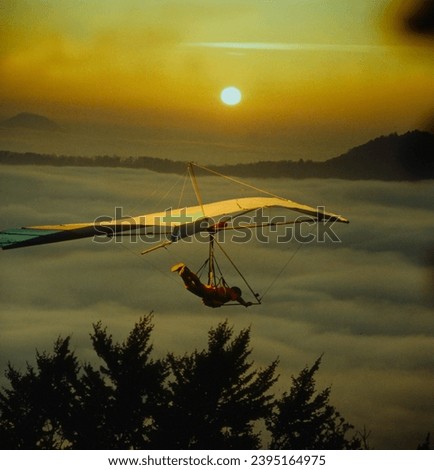 Hang-glider in the sundown, sunset Royalty-Free Stock Photo #2395164975