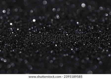 Glitter vintage lights background, light silver and black, defocused.
