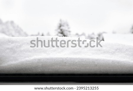 Snow buildup outside of window sill after snow storm or arctic winter blast. Safety problems with snow and ice build up for structure and insulation. Vancouver, BC, Canada. Selective focus. Royalty-Free Stock Photo #2395213255