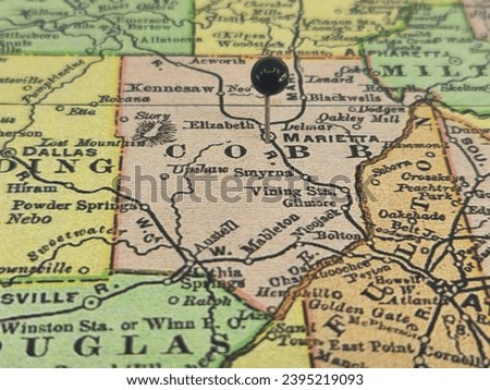 Cobb County, Georgia marked by a black tack on a colorful vintage map. The county seat is located in the city of Marietta, GA. Royalty-Free Stock Photo #2395219093