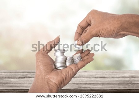hand holding money coins blurry background