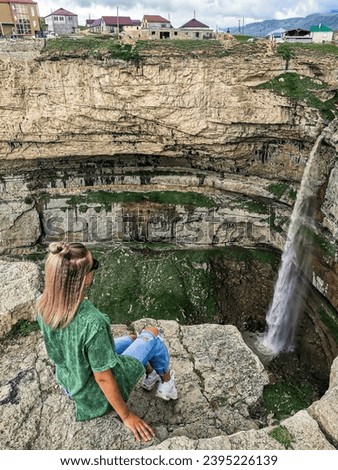 Girl on the background of Tobot waterfall, Khunzakh waterfalls, Dagestan Russia