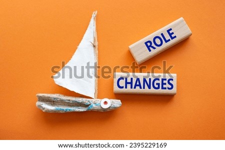 Role changes symbol. Concept words Role changes on wooden blocks. Beautiful orange background with boat. Business and Role changes concept. Copy space.