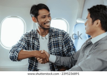 Two business men talking while boarding an airplane Smiling man holding hands