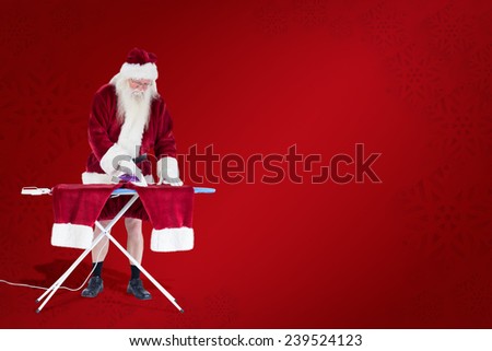 Santa is ironing his pants against red background