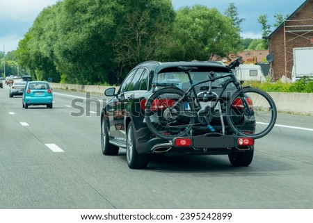 View of car transports bicycles on a rack on highway.