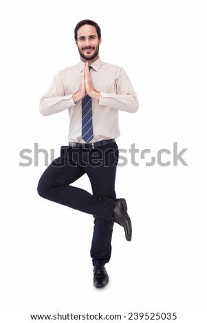Smiling businessman standing in tree pose on white background