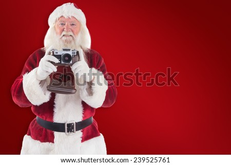 Santa is taking a picture against red background