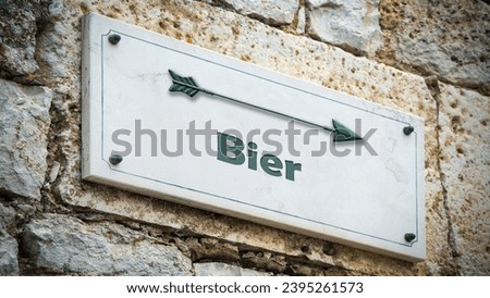 the picture shows a signpost and a sign that points in the direction of beer in german.
