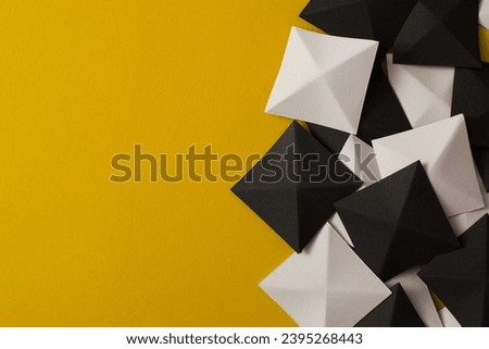 Black and white geometric 3d shapes on yellow background