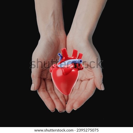 Women's Hand clutching a Red Heart, Love and Health Care Concept.World Heart Day and World Health Day are both celebrated on the same day.It's Valentine's Day.