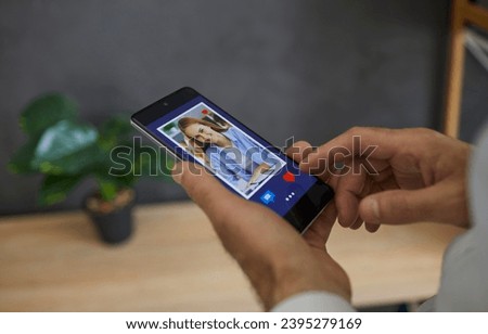 Close up of a man flipping through profiles on a dating site or in an app pressing a red heart as a sign of sympathy for the girl who appeared on the screen. Single man uses a smartphone to find love.