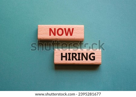 Now Hiring symbol. Concept word Now Hiring on wooden blocks. Beautiful grey green background. Business and Now Hiring concept. Copy space