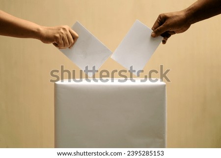 election box, election day concept, people's hands putting ballot envelopes into the election box. Royalty-Free Stock Photo #2395285153