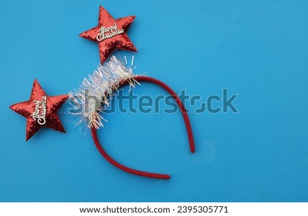 decorated Beautiful headband funny red star isolate on a blue backdrop.
concept of joyful Christmas party,New year is coming soon, festive season decoration with Christmas elements