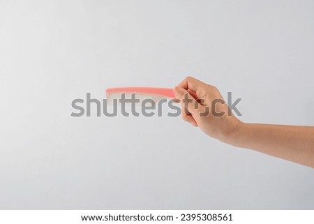 Hand and hair comb isolated on white background