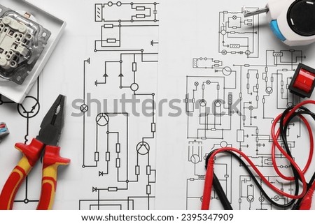 Different electrician's equipment and pliers on wiring diagrams, flat lay Royalty-Free Stock Photo #2395347909