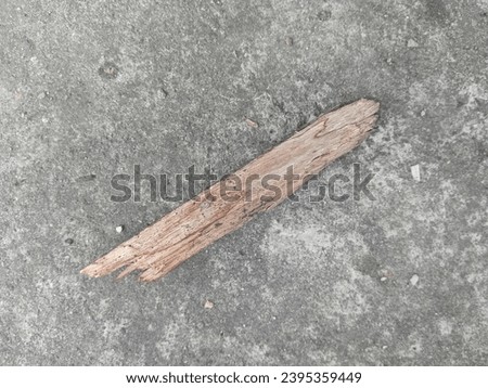 A piece of brown wood lying on the floor