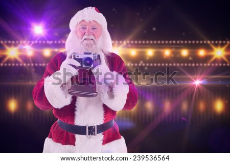Santa is taking a picture against digitally generated nightlife light design