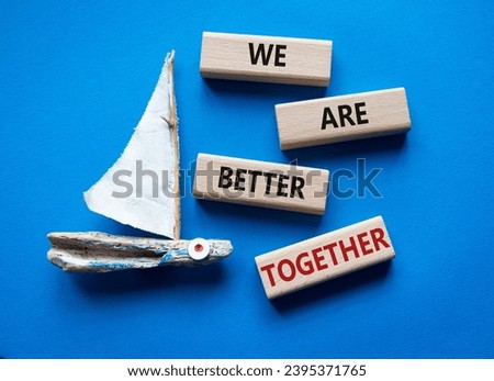 We are stronger together symbol. Wooden blocks with words We are stronger together. Beautiful blue background with boat. We are stronger together concept. Copy space.