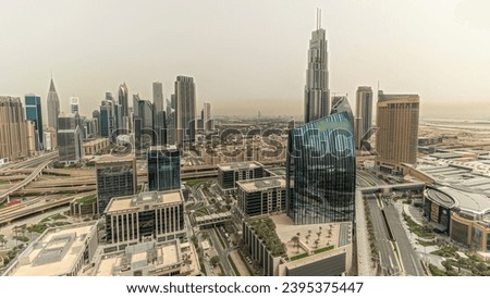 Panorama showing futuristic Dubai Downtown and financial district skyline aerial. Many towers and skyscrapers with traffic on streets. City walk district on a background