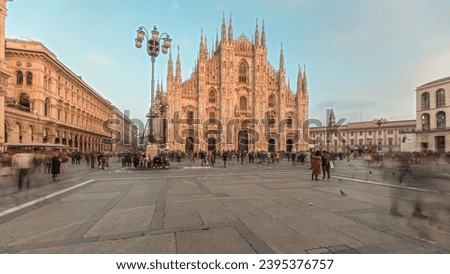 Panorama showing Milan Cathedral and historic buildings timelapse during sunset. Duomo di Milano is the cathedral church located at the Piazza del Duomo square in Milan city in Italy Royalty-Free Stock Photo #2395376757