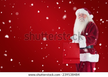 Santa carries red gift bag against red background