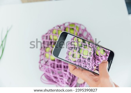 Woman taking pictures with her phone of vegetables for diet