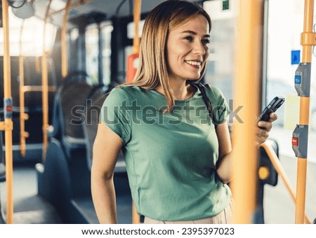 Lifestyle portrait of a young businesswoman sitting with smart phone at the modern train. Woman on a cellphone in public transport.