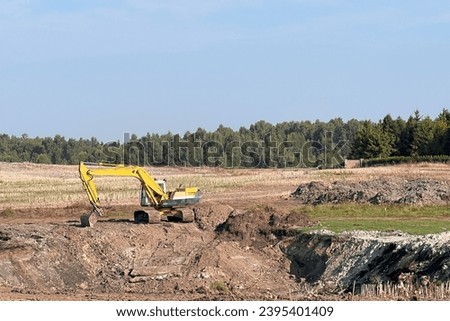 Modern Construction Machinery in Action. View of the mobile crane with a truck. Cable-controlled crane on a truck-type carrier and as self-propelled. Construction site in Europe. Royalty-Free Stock Photo #2395401409