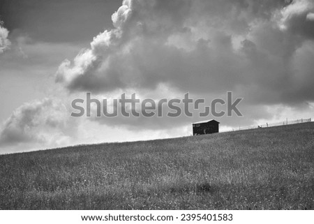 wooden sheepfold in the field Royalty-Free Stock Photo #2395401583