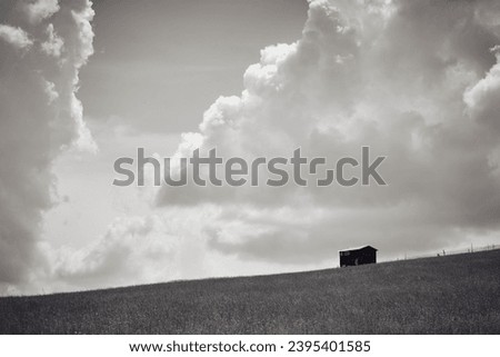 wooden sheepfold in the field Royalty-Free Stock Photo #2395401585