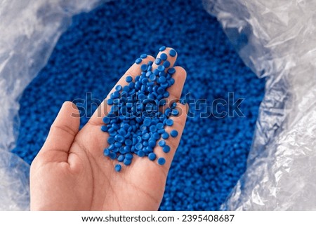 White plastic grain, plastic polymer granules,hand hold Polymer pellets, Raw materials for making water pipes, Plastics from petrochemicals and compound extrusion, resin from plant polyethylene. Royalty-Free Stock Photo #2395408687