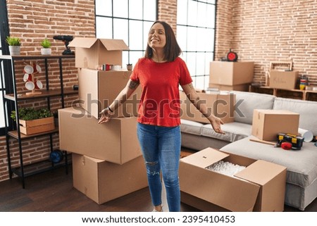 Young beautiful hispanic woman smiling confident standing at new home