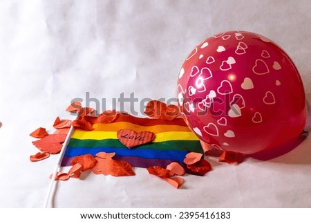 Valentine's day homosexual couple balloon LGBT flag heart and petals on white background gift or surprise for couple on Valentine's day