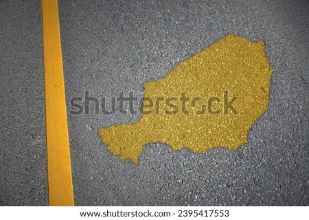 yellow map of niger country on asphalt road near yellow line. concept