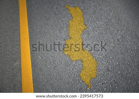 yellow map of malawi country on asphalt road near yellow line. concept