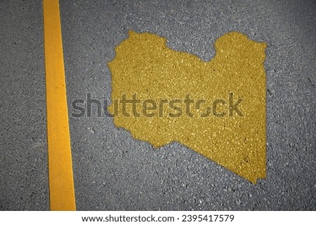 yellow map of libya country on asphalt road near yellow line. concept