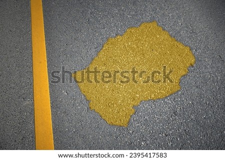 yellow map of lesotho country on asphalt road near yellow line. concept