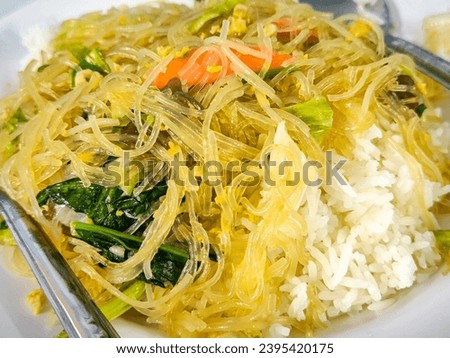 Stir fried Korean glass noodle with soy sauce called Japchae and rice