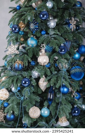 A close-up of a Christmas tree decorations background (blue and golden colors)