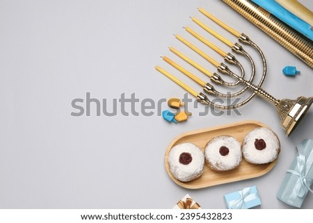 Flat lay composition with Hanukkah menorah and gift boxes on light grey background. Space for text