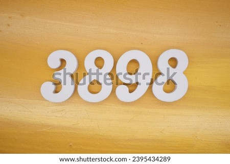 The golden yellow painted wood panel for the background, number 3898, is made from white painted wood.