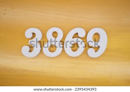 The golden yellow painted wood panel for the background, number 3869, is made from white painted wood.