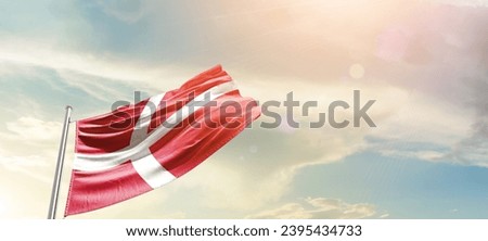Denmark national flag waving in beautiful sky. The flag waving with dynamic angle.