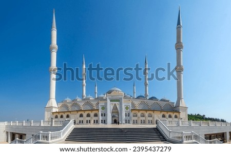 Camlica Mosque of Istanbul front view of main entrance porch -Arabic prayer inscriptions and staircase, Turkey. Panorama, panoramic view of the square. Royalty-Free Stock Photo #2395437279