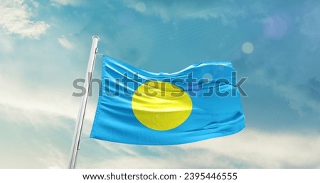 Palau national flag waving in beautiful sky. Royalty-Free Stock Photo #2395446555