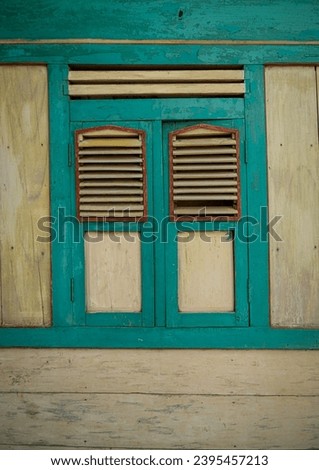 Old wooden windows, traditional Javanese wooden windows, windows commonly used in houses in Central Java, Indonesia, in the past. Royalty-Free Stock Photo #2395457213